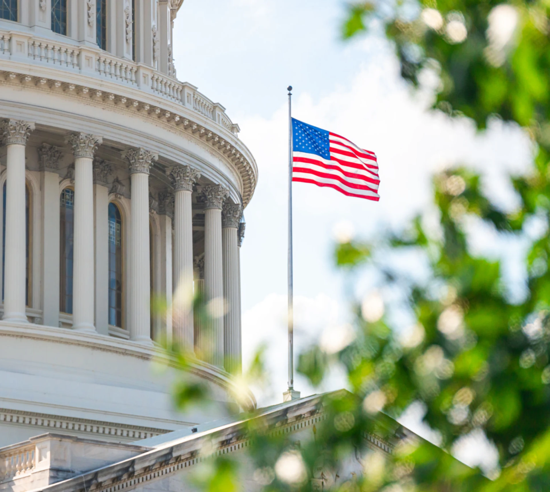 American flag flying near Capitol dome